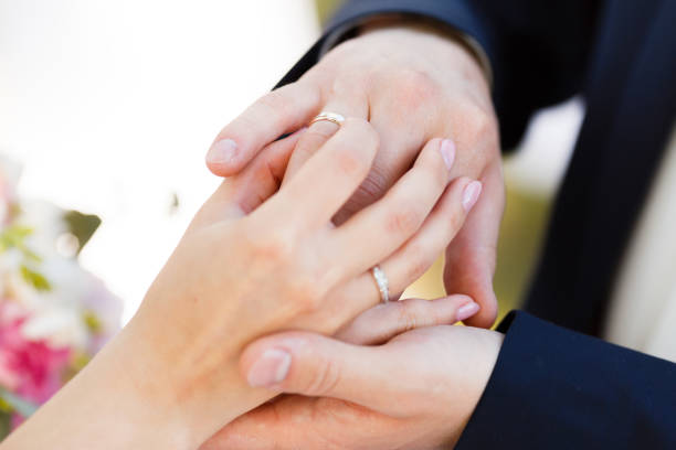 istock Newlyweds put each other rings on the ceremony 1164682208