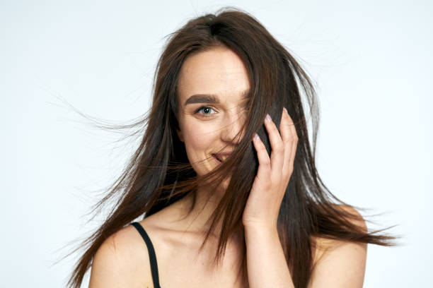 istock Woman smiles on a light background 1164682255