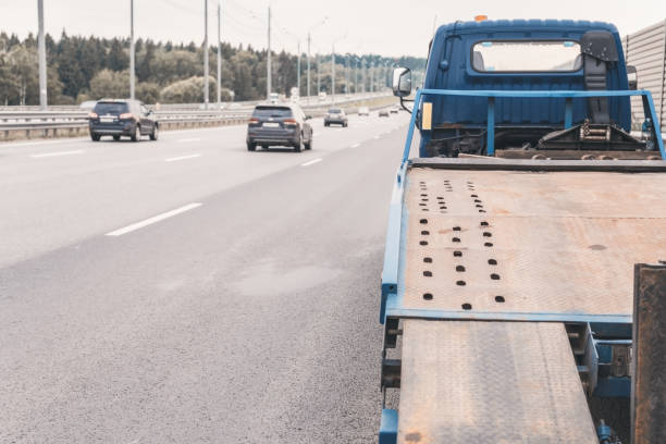 istock Tow truck towing a broken down car on the highway 1164682643