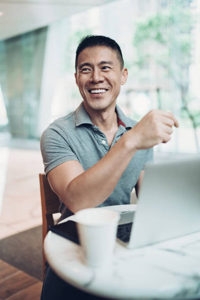 Smiling middle age man with a laptop