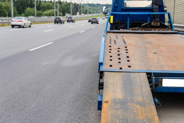 istock Tow truck towing a broken down car on the highway 1164683479