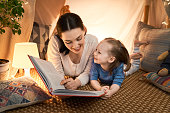 mother and daughter playing in tent