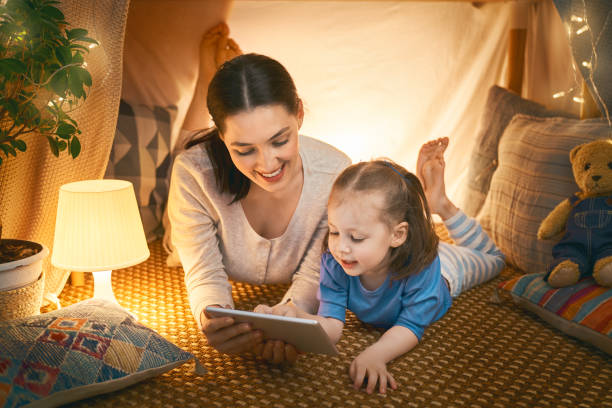 istock mother and daughter playing in tent 1164684643