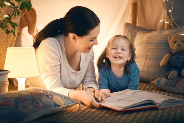 istock mother and daughter playing in tent 1164684647