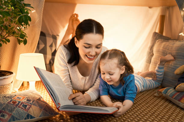 istock mother and daughter playing in tent 1164684659