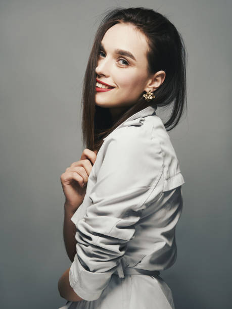 istock Woman smiles on a light background 1164684793