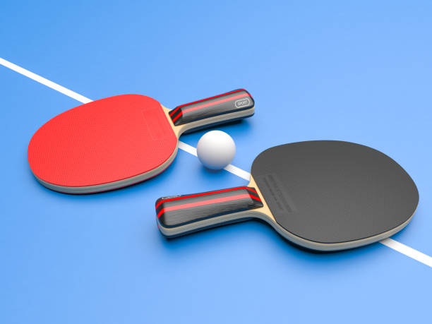 istock Red and black table tennis rackets with ball. On blue background 1164685092