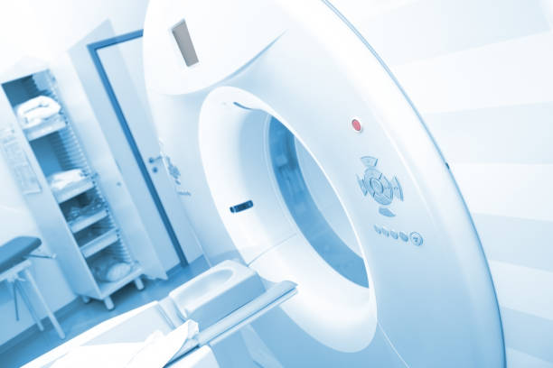 CT scan machinery with empty bed in the hospital room.