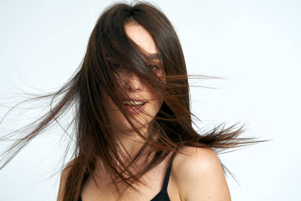istock Woman smiles on a light background 1164686432