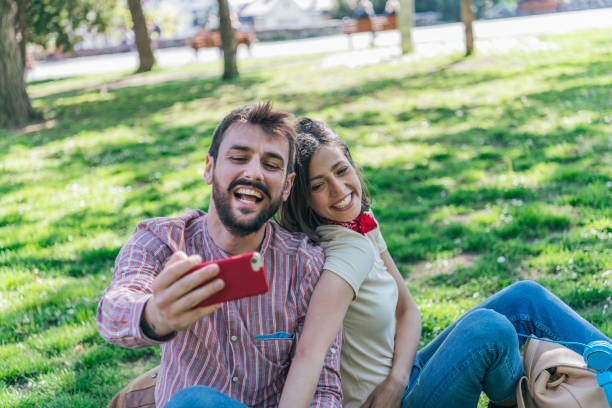 istock Young Attractive Couple is Having Fun in the Public Park 1164691433