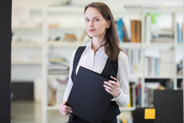 istock Business woman holding files 1164693152