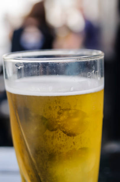 istock Pint of cider on an outside table at a pub. 1164693184