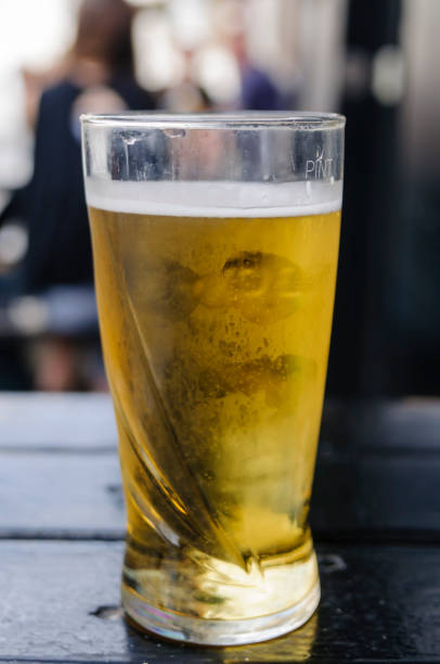 istock Pint of cider on an outside table at a pub. 1164693256