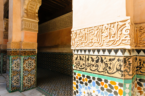 Mosaics, and carved stonework dictating Arabic poetry outside a building in Marrakech