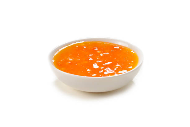 istock Orange sauce in white plate on white background. 1164695010