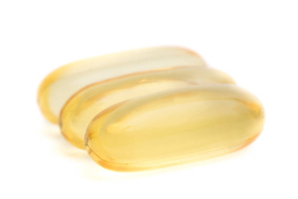 istock Fish oil capsules closeup isolated on white background 1164695051