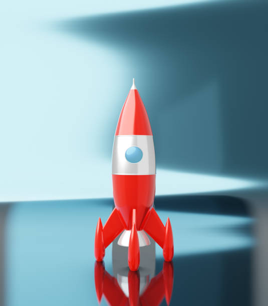 istock Toy space rocket red and white colors on a blue white metalic background. Sci-fi illustration. 3d rendering. 1164698705