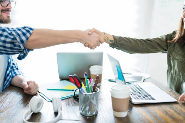 istock Business Colleagues Doing Handshake In Board Meeting 1164699871