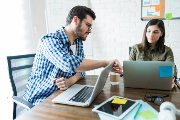 istock Young Professionals Working On Laptop At Office 1164700152