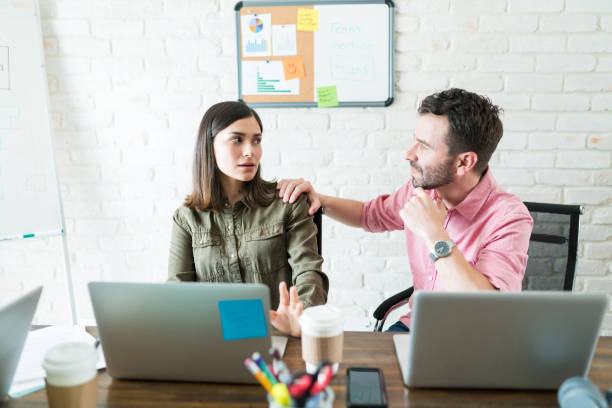 istock Male And Female Executives At Desk In Workplace 1164700347