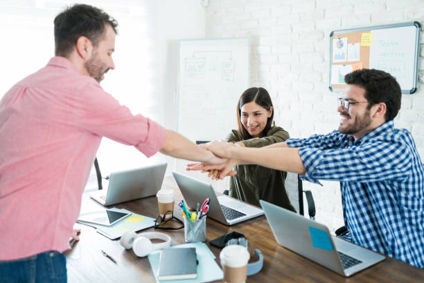 istock Business Professionals Making Pile Of Hands For New Beginnings 1164700674