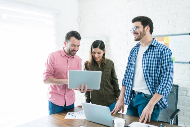 istock Colleagues Communicating Over Laptop At Office 1164701433