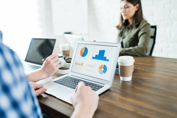 istock Professional Examining Charts In Meeting Room 1164701569