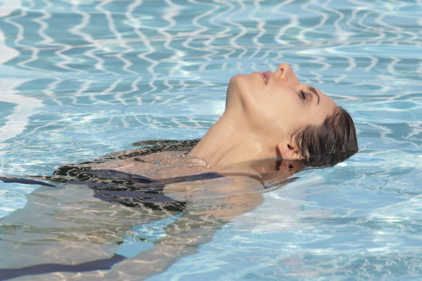 istock Attractive girl in a swimming pool 1164701976