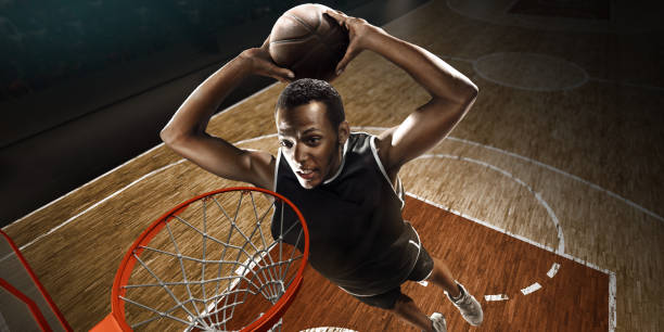 istock African American basketball player makes a basket. High-angle shot. 1164701997