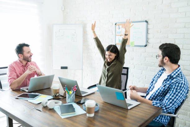 istock Coworkers Cheering After Success In Board Room 1164702695