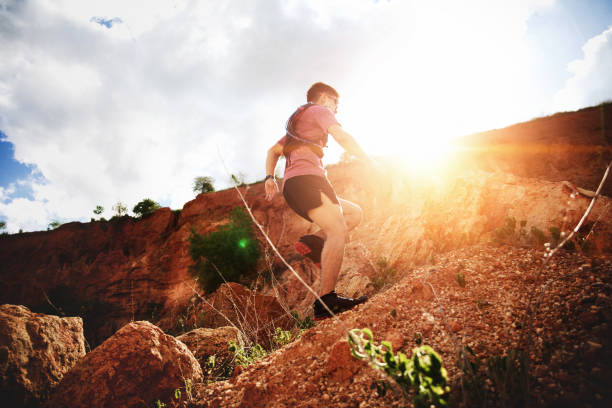 istock trail runner running on the rocky road 1164702799