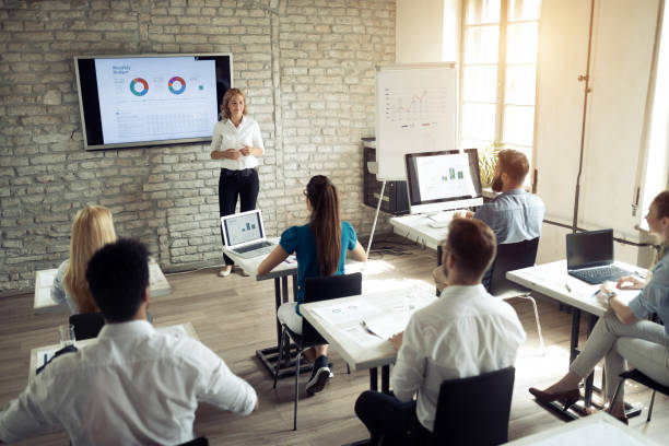 istock Successful happy group of people learning software engineering and business during presentation 1164703320