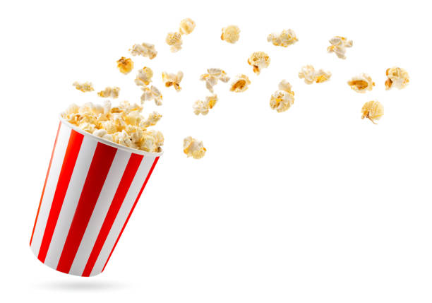 Popcorn flies out of a full bucket close-up on a white. Isolated. Popcorn flies out of a full bucket close-up on a white background. Isolated. popcorn stock pictures, royalty-free photos & images