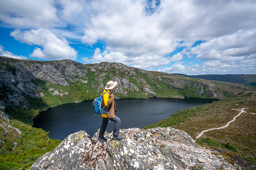 Woman Adventurer Tourist Ascending to Mount Mangart Summit and Enjoying the Views of Mountains Landscape