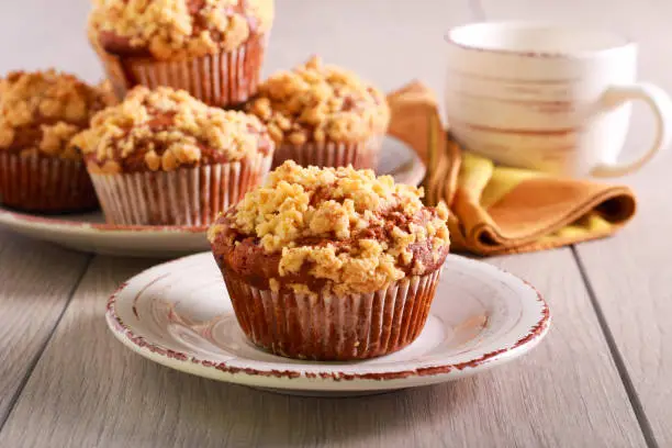 Fruit muffins with crumble topping, served on plate