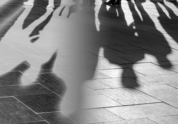 istock Silhouettes and Shadows of People on Sidewalk as Background 1164707910