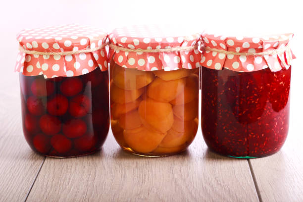 three jars with homemade preserves - preserves jar apricot marmalade imagens e fotografias de stock