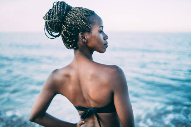 istock African woman having fun at beach 1164711275