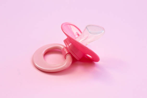 istock Baby pacifier on a pink background 1164711817