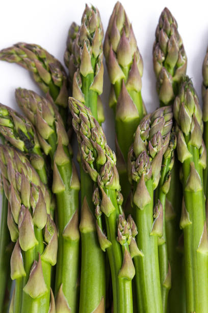 istock A bunch of asparagus laying on white background 1164712744
