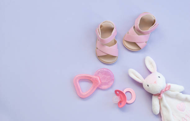 istock the pink baby shoes, pacifier, teether and rabbit toy 1164713782