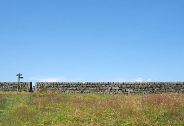 Rural wall against a blue sky.