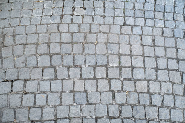 istock Texture of old Cobbled Pavement close-up. Abstract Granite Stone Background. 1164714749