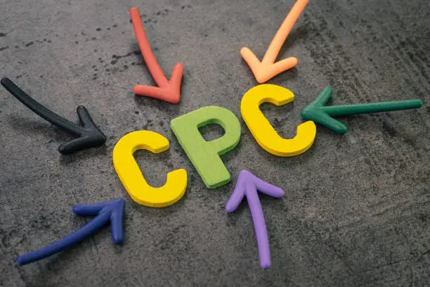 Photo of CPC, cost per click the main KPI for online advertising industry, colorful arrows pointing to the word COST at the center on chalkboard wall