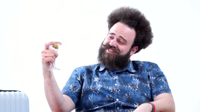 Drunk bearded tourist drinking martini