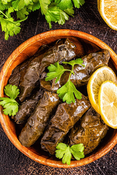istock Dolma, stuffed grape leaves with rice and meat on dark background 1164717302