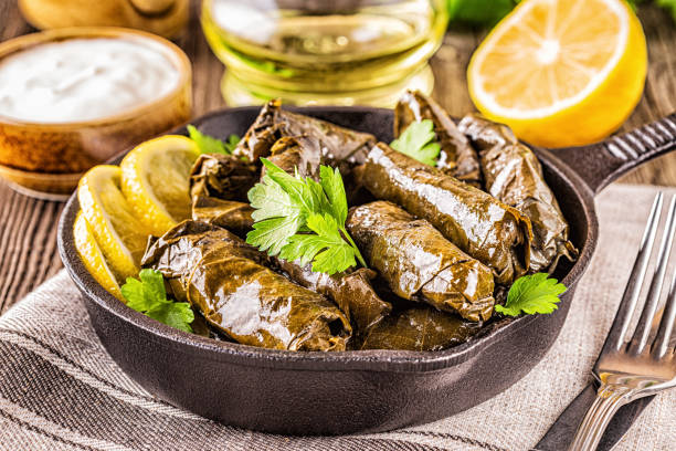istock Dolma, stuffed grape leaves with rice and meat on dark background, selective focus 1164717366
