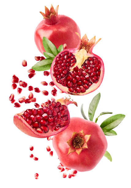 flying in air fresh ripe whole and cut pomegranate with seeds and leaves - romã imagens e fotografias de stock