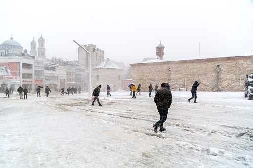 Istanbul, Turkey - January 7, 2017: Istanbul under heavy snow on January 7. The locals and visitors enjoy walking on snow on Istiklal Avenue and Taksim Square, Istanbul Turkey. Istanbul gets 10-15 snowy days per year.