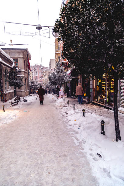 Istanbul, Turkey - January 7, 2017: Istanbul under heavy snow on January 7. The locals and visitors enjoy walking on snow on Istiklal Avenue and Taksim Square, Istanbul Turkey. Istanbul gets 10-15 snowy days per year.